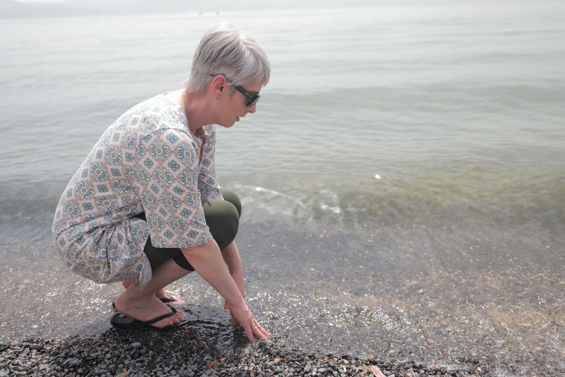 A traveler pausing at the shore of the Sea of Galilee
