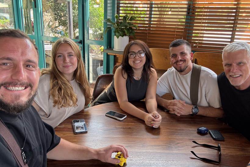 Philip sharing a table with friends in Israel